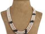 a close up of a necklace on a mannequin mannequin