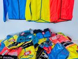 several different colored jackets and pants hanging on a clothes rack