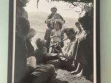 black and white photograph of a group of people sitting under a tree