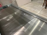 a stainless steel floor in the middle of a kitchen