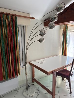 a table with a lamp and a chair in a room
