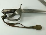 a sword with a long blade on a white surface