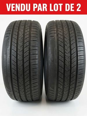 a pair of tires on a white background with the words vendu par lot de 2