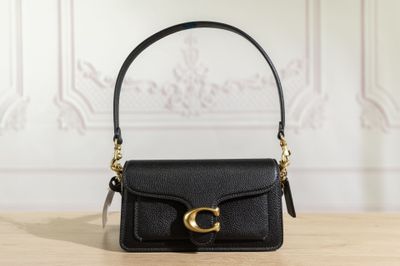 un sac à main noir posé sur une table en bois
