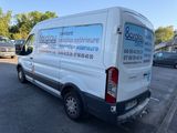 the back of a white van parked in a parking lot