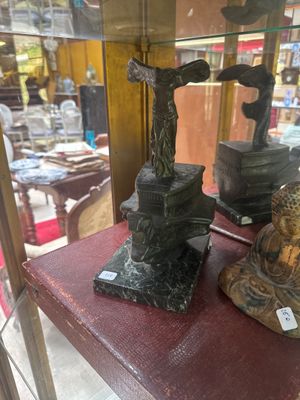 two statues on display in a glass case