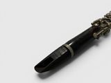 a pen with a chain attached to it on a white surface