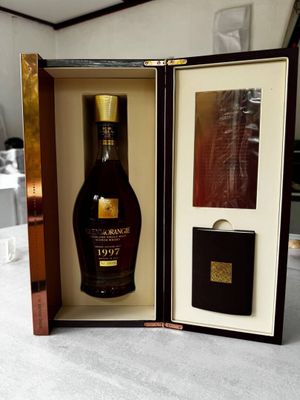 a bottle of brandy in a wooden case