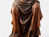 an old statue of a woman holding a baby in her arms