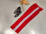 a pair of black shoes and a pair of red pants next to a pair of black shoes