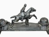 a statue of a man riding a horse with a helmet on it