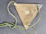 a small triangle shaped object with a string around it