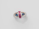 a close up of a ring with two blue and pink stones