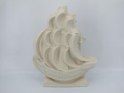 a white sculpture of a ship on a white background