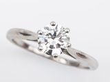 a close up of a diamond ring on a white background