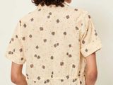 a woman wearing a short sleeved shirt with hearts on it