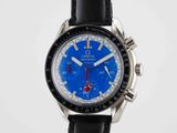 a close up of a watch with a blue face on a black strap