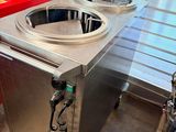 a picture of a kitchen with two sinks and a red counter