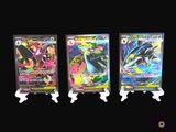 three different types of pokemon cards on display on a black background