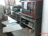 a picture of a kitchen with a microwave and a counter