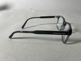 a pair of glasses sitting on a white surface