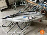 a boat that is sitting on a rack in the garage