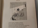 an open book with a picture of a man sitting on a bed