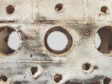 a close up of a piece of metal with holes in it