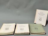 three books sitting on top of each other on a table