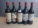 six bottles of wine are lined up on a table