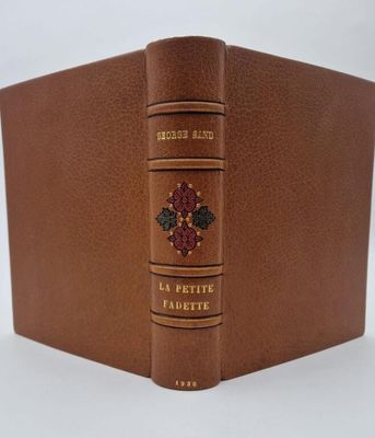 an image of a brown leather book with a flower on it