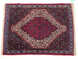 a red rug with a medallion design on it
