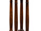 a small wooden table with three pillars on it
