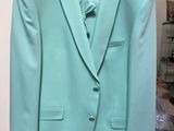 a suit hanging on a hanger in a room