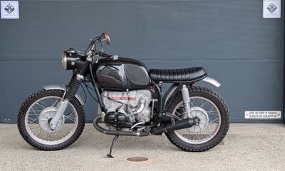 a black motorcycle parked in front of a garage door