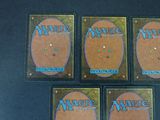 four magic the gathering deck protectors are sitting on a table