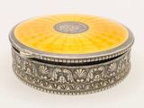 an image of a silver and yellow box on a white surface