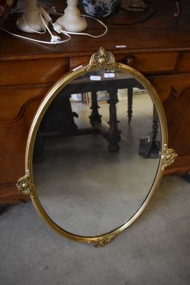 a mirror that is sitting on the floor in front of a dresser