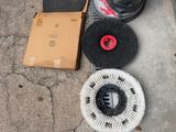 a lot of cleaning supplies on the sidewalk next to a box