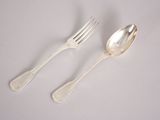two silver spoons and a fork on a white surface