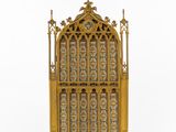 a gold and blue stained glass window with a cross on top
