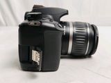 a black camera with a flash drive attached to it