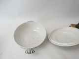 a white bowl and a white bowl on a table