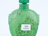 a green glass bottle with a bird on it