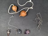 a picture of a necklace with various items on it