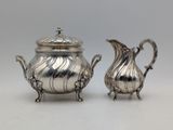 a pair of silverplated teapots and a creamer