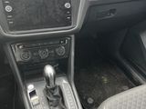 the interior of a car with a steering control and dashboard controls