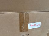 a cardboard box with a sticker on it sitting on the floor
