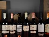 several bottles of wine are lined up on a shelf in a wine cellar