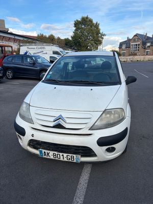 white citrole parked in a parking lot with other cars in the background